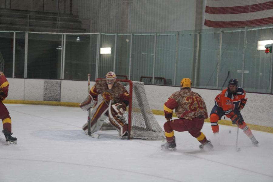 During the Iowa State VS University of Illinois hockey game on January 26th, sophomore Anthony Song is helping keep the puck away from goal in attempt to keep their 2-2 tie.