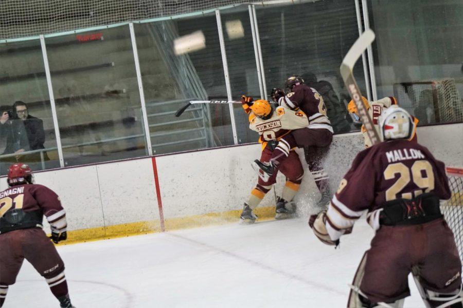 Freshman Jared Erickson checked a Rob Morris player in an attempt to steal back the puck during the Iowa State VS Rob Morris hockey game on January 19th.