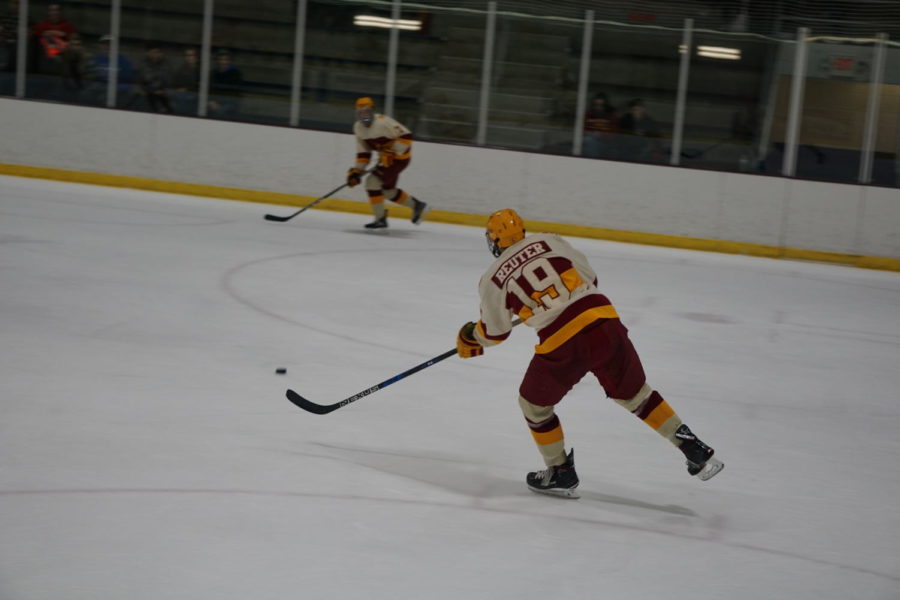 Senior Kody Reuter passes the puck to another cyclone player during the Iowa State vs Ohio University hockey game on February 17th. The Cyclones lost to the Bobcats 6-1.