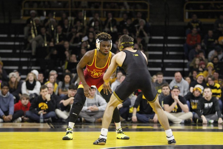Redshirt freshman Markus Simmons eyes down the Iowa wrestler in the beginning part of his 125-pound match. Simmons would lose the match in a 19-4 technical fall in the 26-9 win for Iowa on Dec. 10 in Iowa City, Iowa. 
