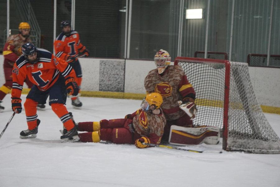 At the Iowa State VS University of Illinois hockey game on January 26th, Freshman Max Olson slips and slides into the goalie.