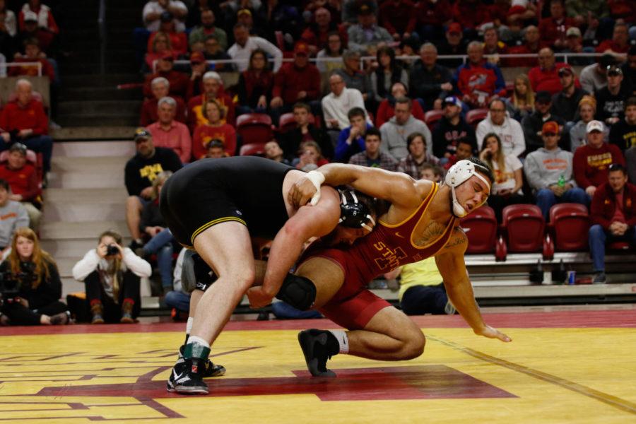 Iowa State redshirt junior Marcus Harrington gets taken down by Iowa's Sam Stoll. Stoll is ranked No. 5 in the nation and beat Harrington 14-4 via major decision. The Hawkeyes rolled over the Cyclones 35-6. 