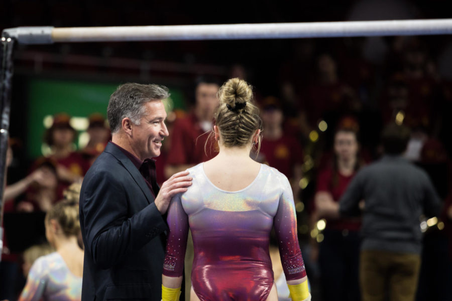 Head Coach Jay Ronayne talks to Sophomore Laura Burns after her bars routine during the Iowa State vs. Texas Womans University meet Jan. 26. The Cyclones defeated the Pioneers 195.275 to 191.050.