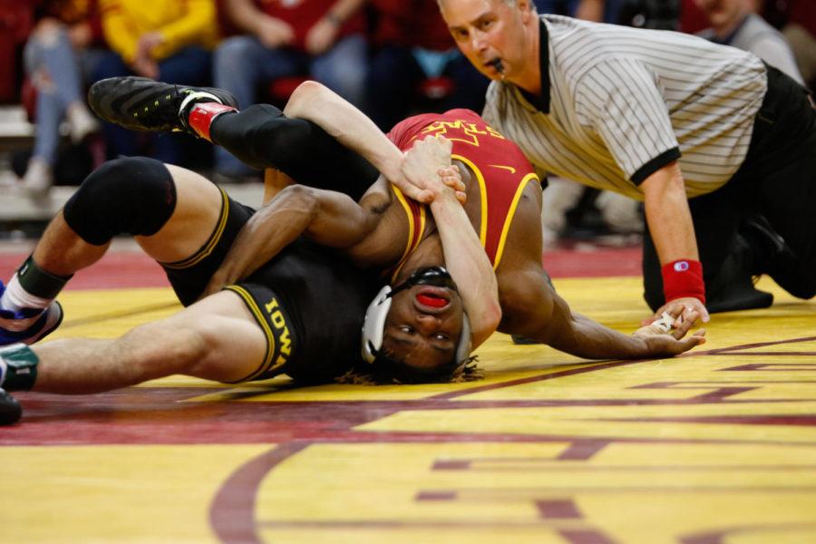 Iowa State redshirt sophomore Markus Simmons tries to escape from Paul Glynn of Iowa. Glynn beat Simmons 8-6 as the Hawkeyes took down the Cyclones 35-6. 