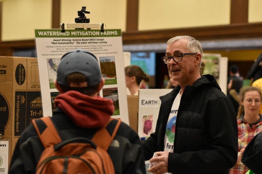 Dr.+Ray+Meylor+of+Cherry+Glen+Learning+Farm+speaks+to+a+student+about+watershed+mitigation+farms+at+Sustainapalooza+on+Feb.+20.%C2%A0