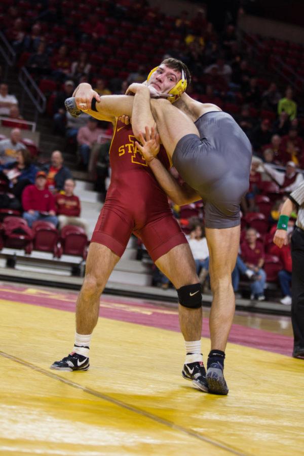 Redshirt Sophomore Chase Straw lifts Northern Colorado wrestler Tyler Kinn into the air Jan. 5 in Hilton Coliseum.  The cyclones were narrowly defeated by the UNC Bears 20-22. 