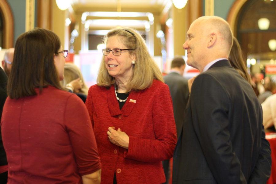 President Wendy Wintersteen talks with Ames Laboratory representatives Alissa Brammer (left) and Adam Schwartz (right) at this years ISU Day at the Capitol on Monday. This is President Wintersteens first year going as president, and she believed it to be a great success. 