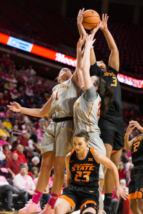 Members of the Iowa State and OSU teams go up for a rebound during the basketball game Feb. 10 in Hilton Coliseum.The cyclones were narrowly defeated by the Cowgirls 73-81