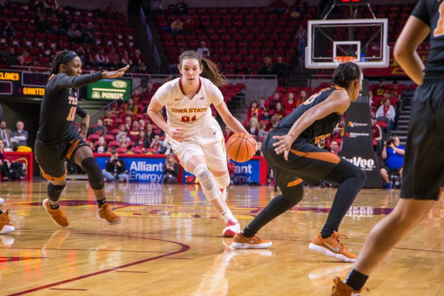 Junior Bridget Carleton moves down the court during their game against the University of Texas on Feb. 24 at the Hilton Coliseum. 