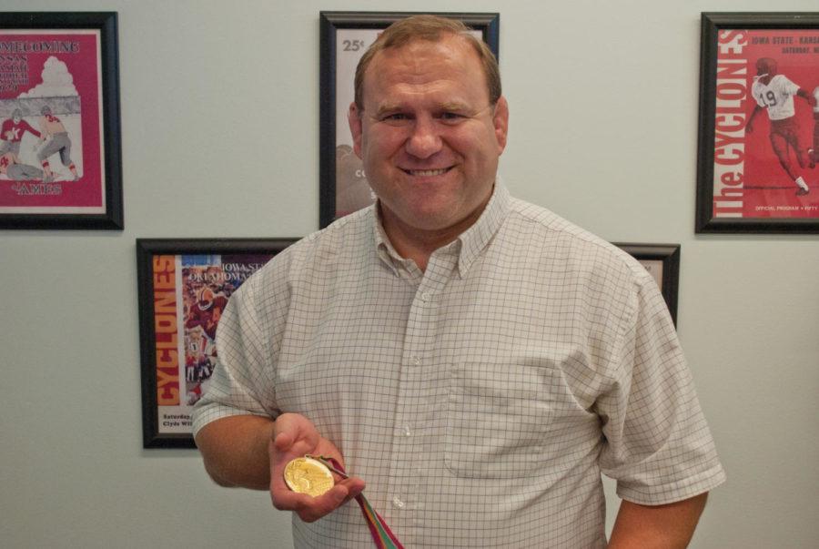 Ed Banach, 1984 Olympic gold medalist in wrestling and former
University of Iowa wrestler, shows off his medal on Tuesday at the
Jacobson Building. Photo: Jordan Maurice/Iowa State Daily
