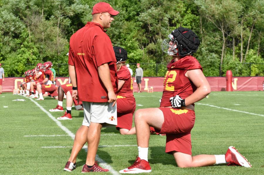 Offensive lineman Sean Foster speaks with offensive coordinator/offensive line coach Tom Manning during practice Aug. 4.