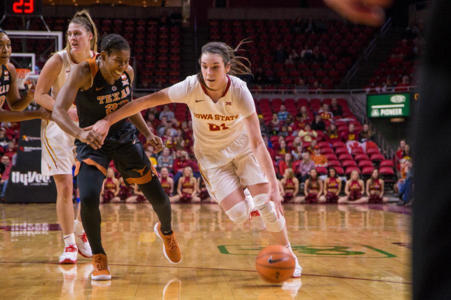 Junior Bridget Carleton moves down the court during their game against the University of Texas on Feb. 24 at the Hilton Coliseum. 