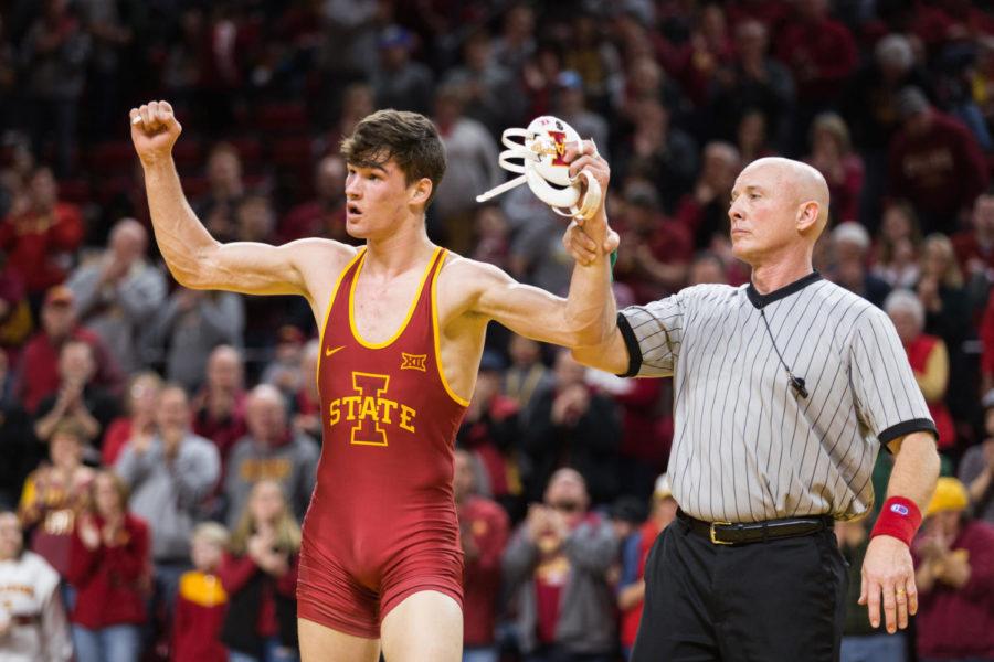 Iowa State redshirt freshman Jarrett Degen flexes to the crowd after winning his weight class against Kyle Rae during the Iowa State vs West Virginia wrestling meet on Jan. 21. The Cyclones defeated West Virginia 25-16. 
