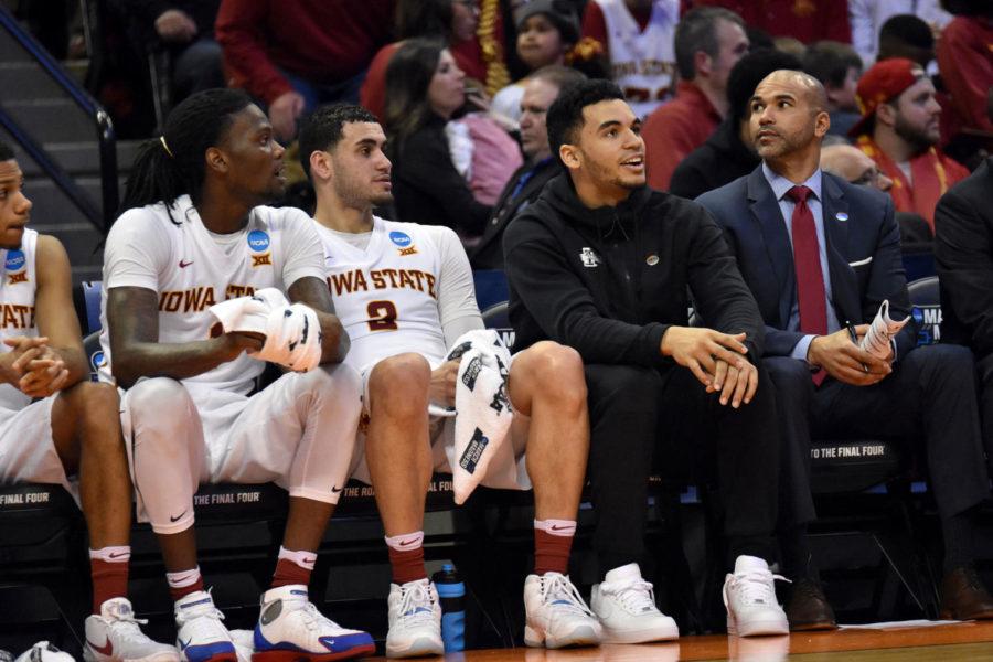 Redshirt senior forward Jameel McKay, redshirt senior forward Abdel Nader, senior guard Nazareth Mitrou-Long and director of basketball operations Micah Byars watch the score at the NCAA Tournament against Iona on March 17 in Denver. Iowa State won 94-81 and will face Arkansas-Little Rock on March 19.