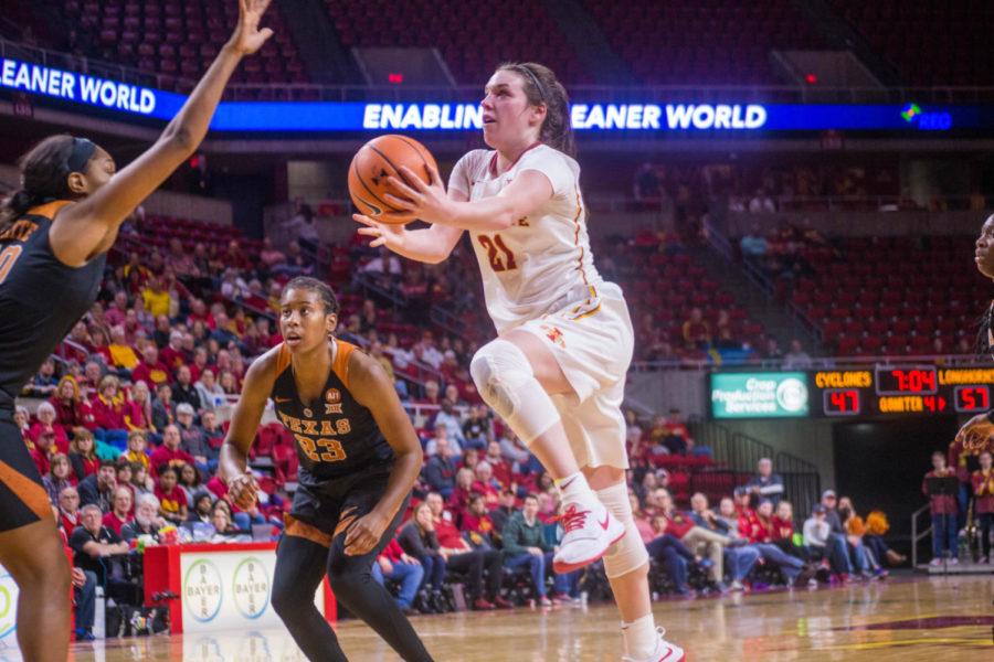 Junior Bridget Carleton moves in for a layup during the game against the University of Texas on Feb. 24 at the Hilton Coliseum.