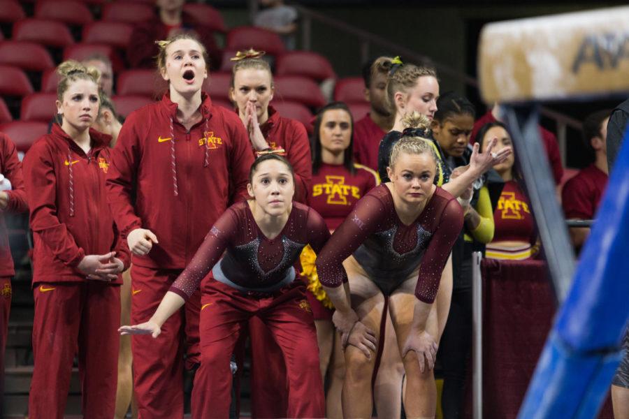 Members of the Iowa State Gymnastics Team watch their teammates compete on beam during the Iowa State, Iowa and Missouri tri-meet. the cyclones won with a team score of 196.700 points.  