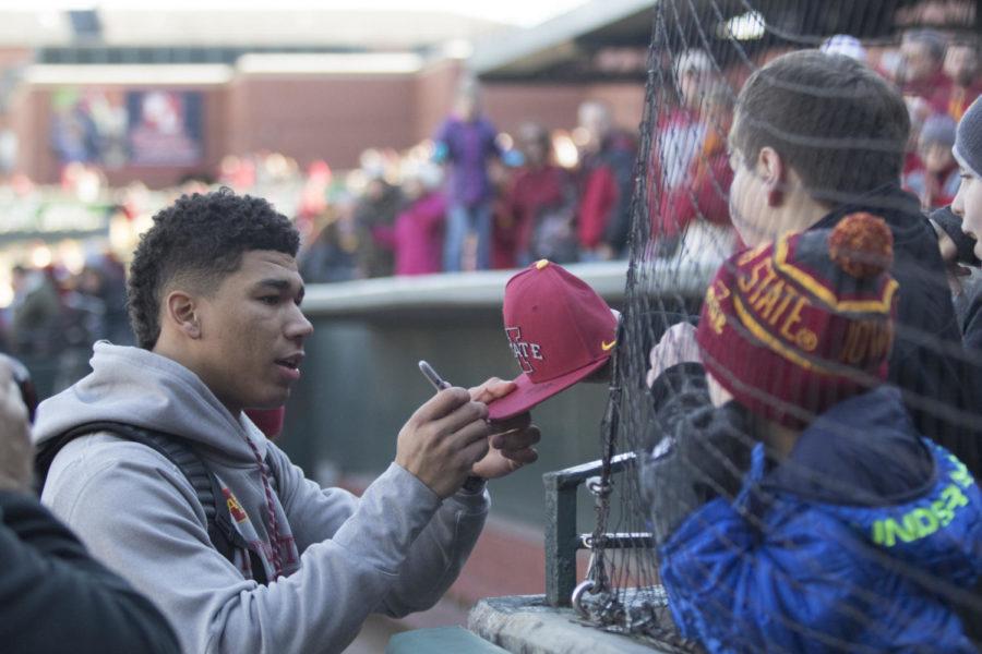 Iowa State senior Allen Lazard signs a hat for a young Cyclone fan at the Cyclone Spirit Rally in Memphis.