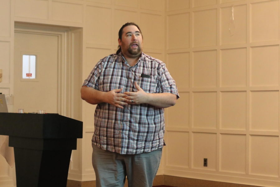 Jeffrey Burnette, assistant professor of economics at the Rochester Institute of Technology, presents at the American Indian Symposium on March 26 in the Cardinal Room of the Memorial Union.