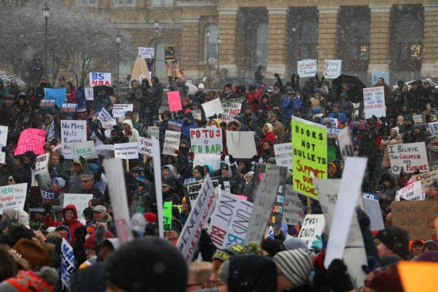 Protesters hold up signs during the March For Our Lives protest on March 24, 2018. Over a thousand people attended the event, which was held at the State Capitol Building in Des Moines. 