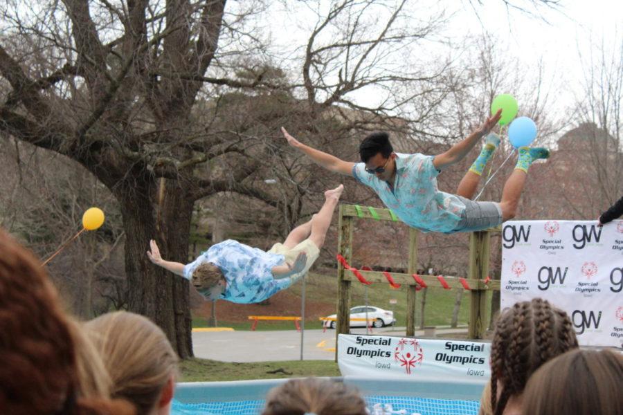 Two fraternity brothers dive into the freezing cold water during the Polar Plunge to benefit the Special Olympics outside of the Memorial Union on April 1. The Greek community together raised nearly $356,000 by the time the plunge started. 