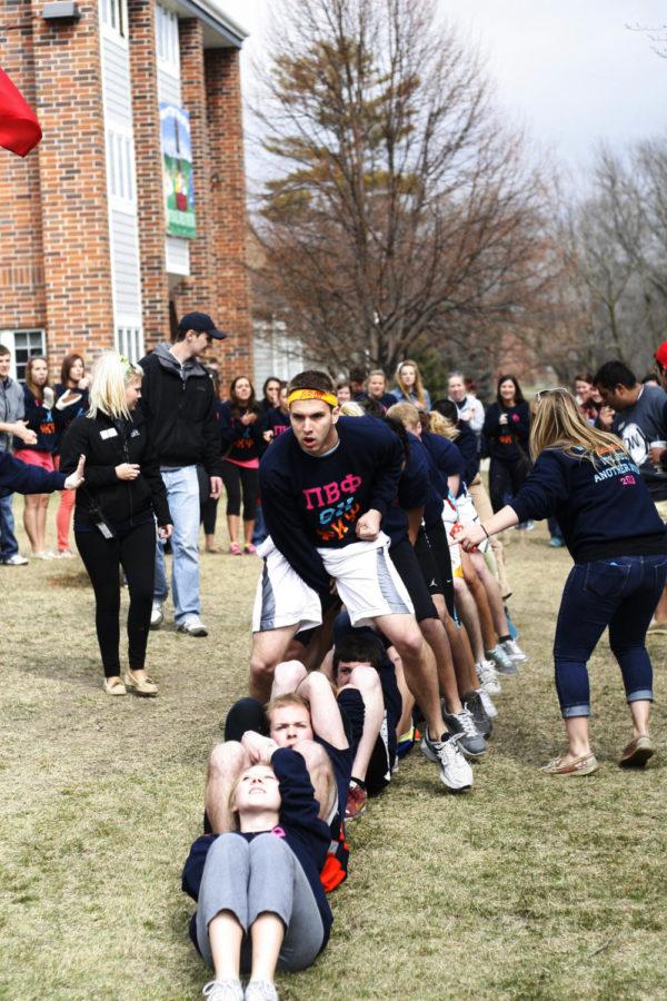 Members of the Pi Beta Phi, Theta Chi and Phi Kappa Psi pairing compete in the Skin the Snake competition for the Greek Week Olympics on Saturday, April 6, 2013, in front of the Phi Gamma Delta fraternity house.
