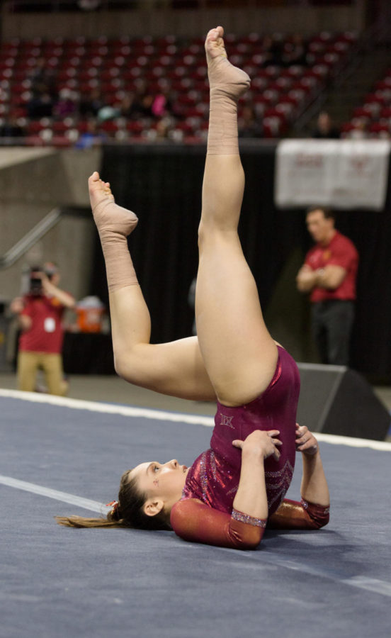 Iowa State Senior Brianna Ledesma balances upside down during her floor routine. Iowa State took third place in the NCAA Big 12 gymnastics championship with a score of 195.650 over West Virginia at 195.625, but behind Oklahoma at 197.775 and Denver at 197.075. 