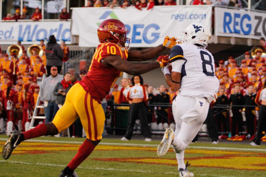 Iowa State defensive back Brian Peavy attempts to tackle West Virginia wide receiver Marcus Simms as he falls into the end zone for a touchdown on Nov. 26 at Jack Trice Stadium. West Virginia led Iowa State 21-16 at halftime.