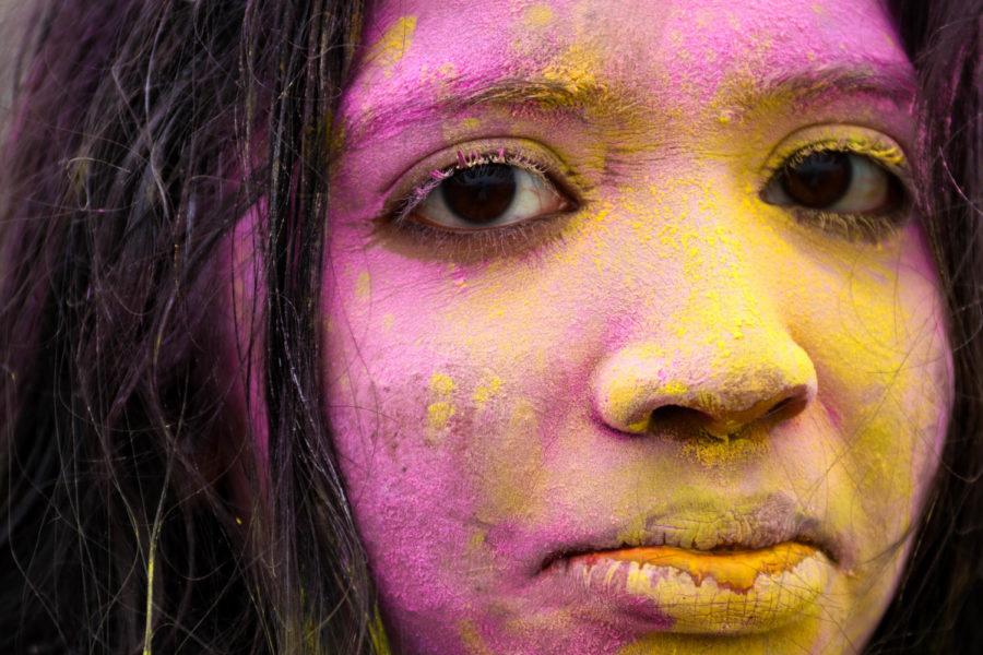 A powder-covered student enjoys a celebration for the Indian festival of Holi put on by the Indian Students' Association on April 21 at the central lawn in Frederiksen Court. 