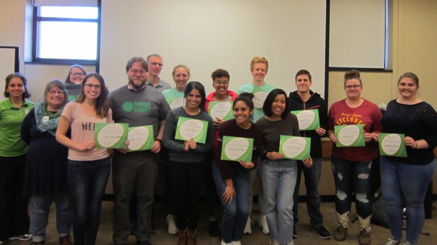 Students who completed the Green Dot bystander training, April 7, stand with their training certificates. 