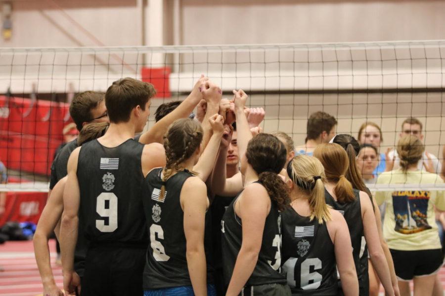 Volleyball players from Psi Psi huddle together before their semifinals match at Greek Weeks volleyball tournament on April 2.