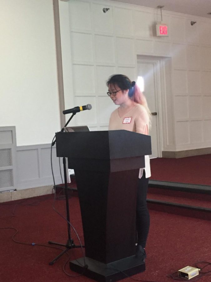 Megan Chuah stands behind the podium talking those in attendance of her presentation, Excuse You: Words that Hurt. Chuah was one of the creators of the campaign done at her former institution, Taylors University in Malaysia.