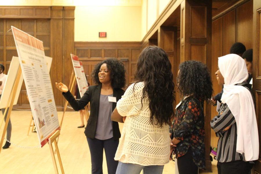 Thomata Doe, presents her poster at the McNair Achievement poster contest in the Memorial Union on April 17.