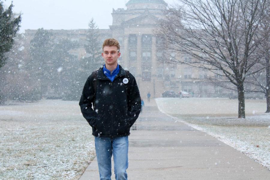 An Iowa State student, Trevor Johnson, walks on Central Campus through a spring snow flurry on April 3. 