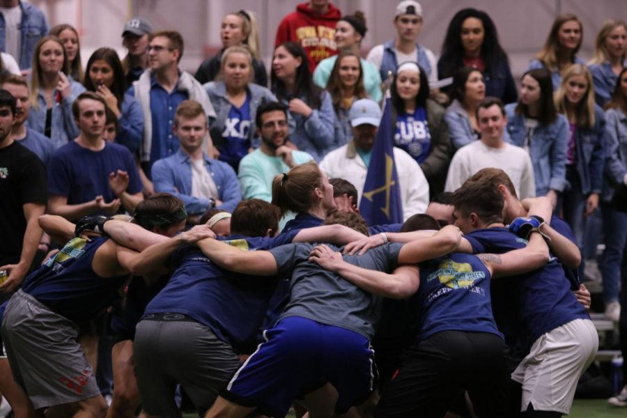 A team huddles and rallies before beginning their football game in Lied Rec Center on April 4. The tournament is part of Iowa State's Greek Week.