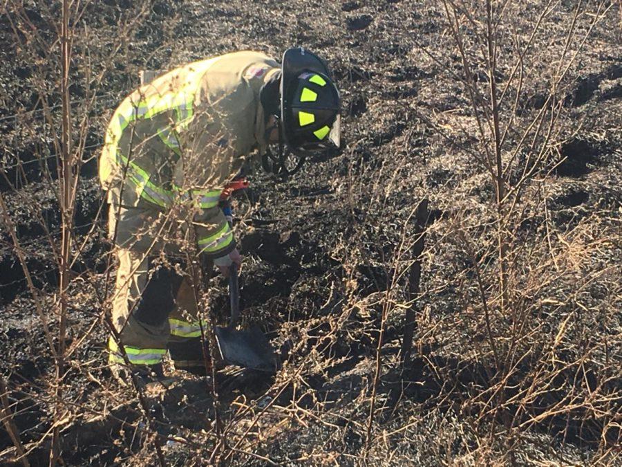 Ames firefighters work to put out a brush fire in a ditch off of Route 30.