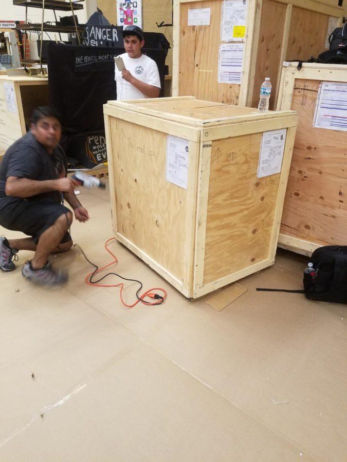 Brian Winns team unloads crates of props shipped from California.