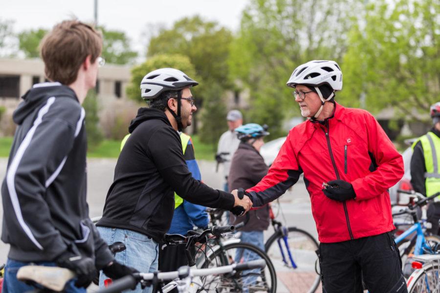 Mayor John Haila shakes hands and greets members of the Ames community before starting the community bike ride on May 12 The bike route started at Ames City Hall and Ended at Ada Hayden Heritage Park.