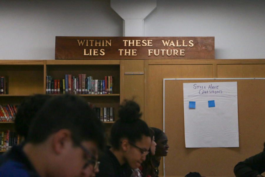 The sign on the shelf in the library at North High School reads within these walls lies the future.