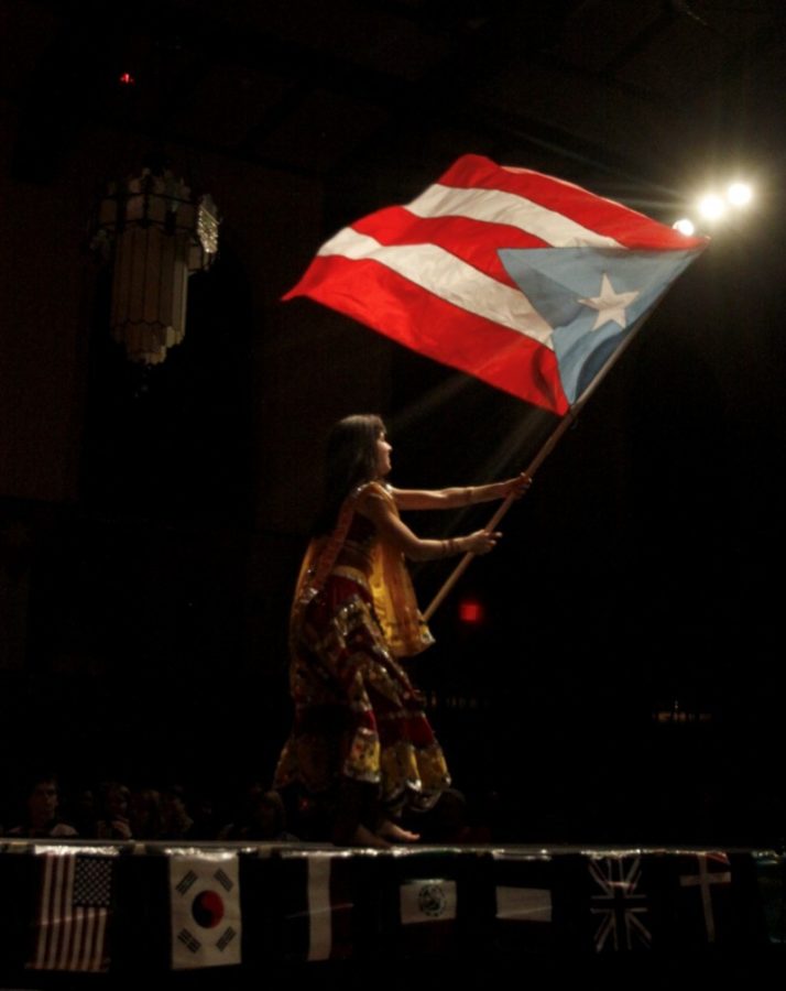 Angelica Figueroa, senior in biology, proudly waves her Puerto Rican flag in the closing performance of the Sixth Annual Global Gala on Fri., March 26. Figueroa was also a dancer in the ChakRAAS performance and served as the head choreographer of the Puerto Rican Student Association/Orchesis II performance. 