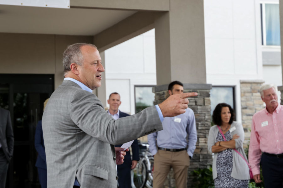 Tim O'Byrne speaks to a group of Ames residence who have gathered for the opening ceremony at the newly renovated Radisson Hotel. The multimillion hotel renovation included upgrades to its 75 guest rooms and suites, lobby and exterior.