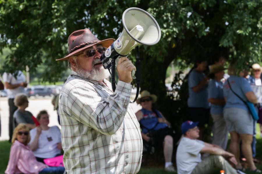 Families Belong Together rally participant reminds everyone to stay hydrated by chanting hippies hydrate though his megaphone.