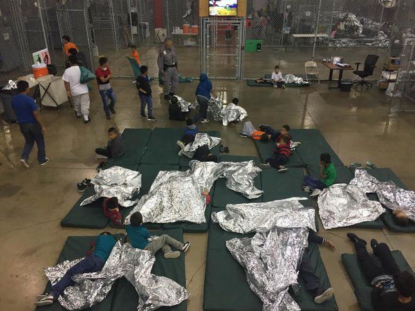 A photo released by U.S. Customs and Border Protection shows children separated from their parents using mylar blankets on sleeping pads gathered on the floor.