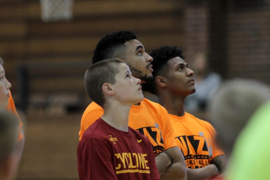 Naz Mitrou-Long and Donovan Jackson look up while a camper shoots during Naz Mitrou-Longs basketball camp on June 9. The camp was hosted by Long and Lyndsey Fennelly as well as current and former Cyclones.