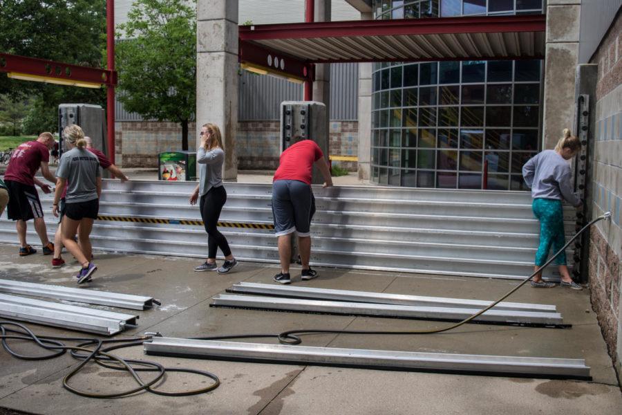 Iowa State Recreation Services students and professional staff members helped install flood barriers outside of Lied Recreation after Ames was hit with over 6 inches of rain on Thursday. Lied remains open despite the barriers.