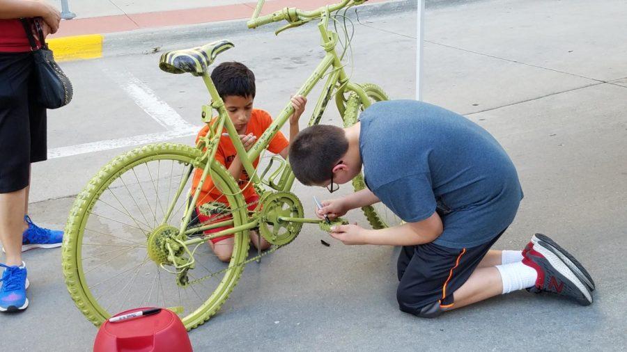 Children in the community decorated the Ames Community Arts Council's bikes at the ArtWalk on Friday. The bikes will be located on Main Street throughout the summer. 