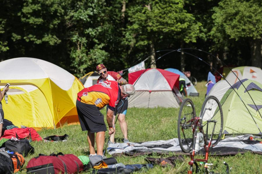 RAGBRAI participant sets up his tent in the reserved sport for Bicyclists of Iowa City in 2018.