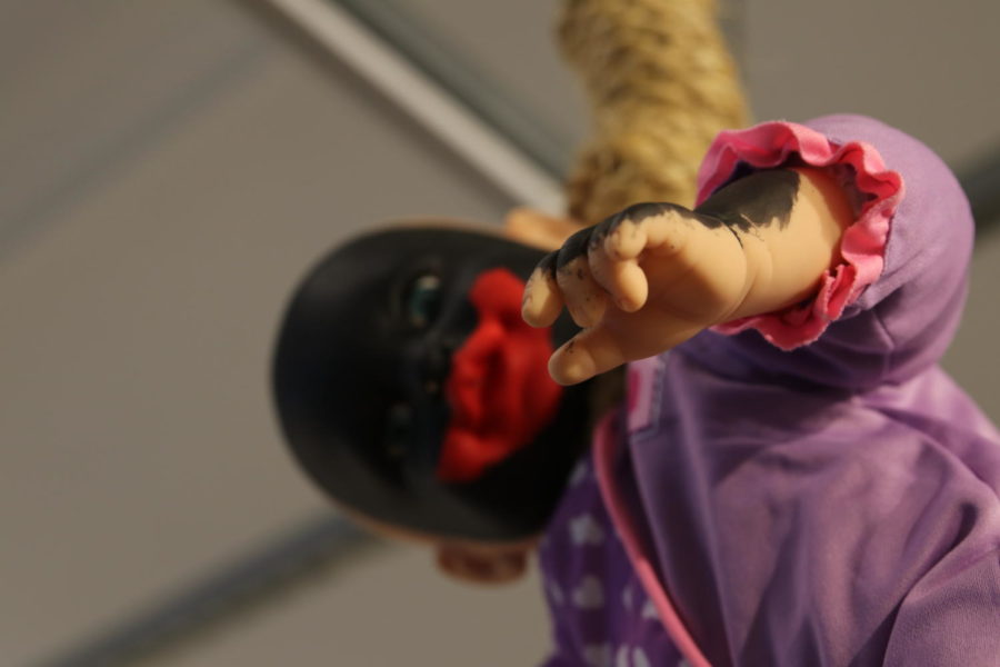 A close-up of Equilibrium shows the detail applied to the hands and forearm of the baby doll in the noose.
