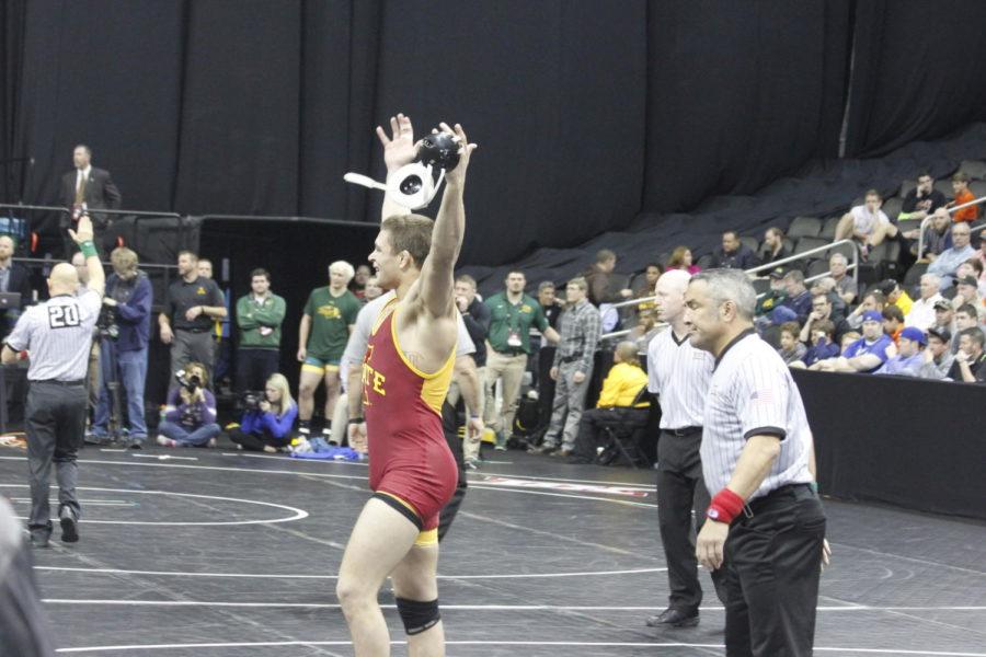 Sophomore Pat Downey raises his hands to pump up the Iowa State crowd after defeating Trent Noon from Northern Colorado. Downey placed third in the 197-pound weight class at the Big 12 Wrestling Championships on March 6 at the Sprint Center in Kansas City. 