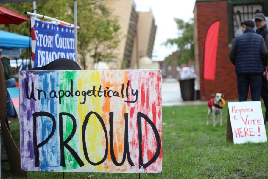 A sign sits outside the tent of a vendor at Ames Pridefest on Oct. 14 at Bandshell Park in Ames. 