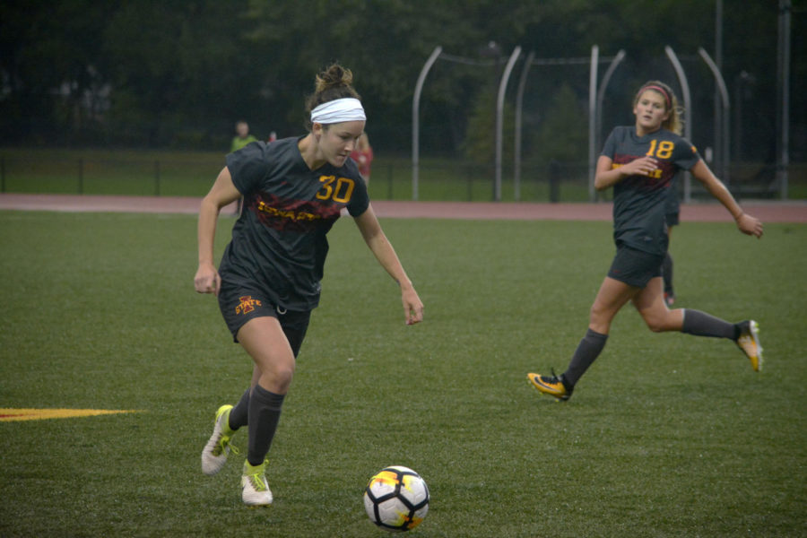 Riley Behan, midfielder/defender, runs the ball down the field during the Cyclones versus Oklahoma game at the Cyclone Sports Complex on Oct. 6. After playing in on and off rain showers the game ended 0-0 in double overtime.
